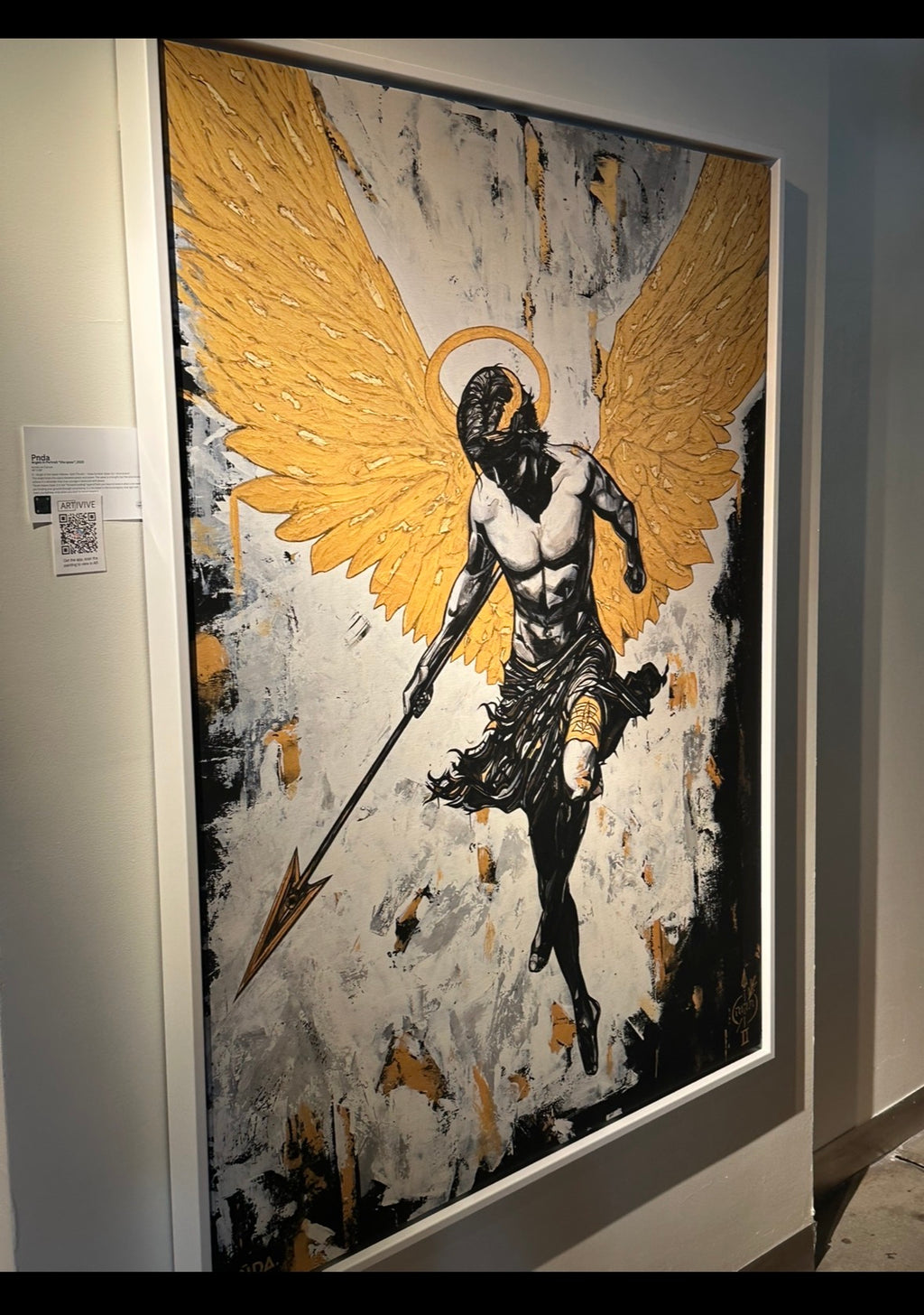 Artistic depiction of an angel with gold wings on a textured background